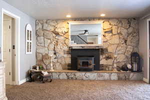 Details with a textured ceiling, recessed lighting, carpet, baseboards, and ceiling fan. Sliding glass doors to covered patio