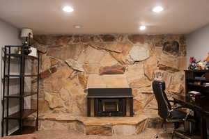 Basement family room with fireplace and stone wall