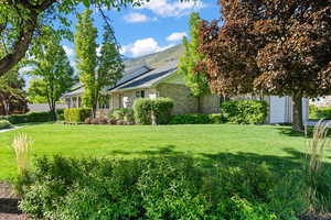 View of yard with an attached garage and basement walkout