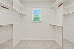 Walk in closet in the primary bedroom