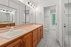 Primary Bathroom with double sinks, walk in closet and en suite with shower and separate bathtub