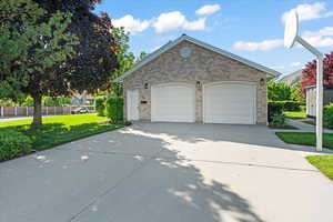 Exterior space featuring extended concrete driveway, double garage and separate basement walkout entrance