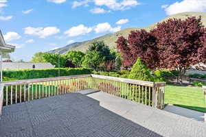 Large wooden deck perfect for outdoor entertaining, featuring a mountain view