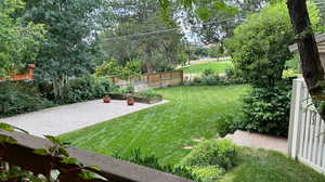 View of yard featuring a vegetable garden and fence