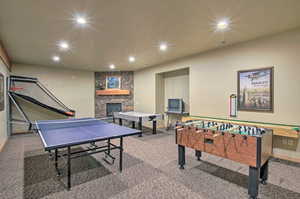 Playroom with visible vents, recessed lighting, carpet floors, a stone fireplace, and baseboards