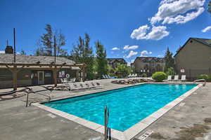 Pool with a patio and fence