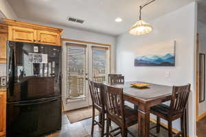 Dining room featuring visible vents and stone tile flooring