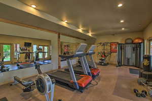 Exercise area with recessed lighting and baseboards