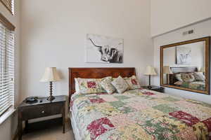 Bedroom featuring carpet and visible vents