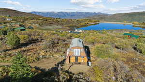 Aerial view featuring a water and mountain view