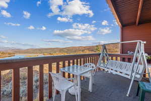 Balcony featuring a water and mountain view