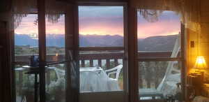 Doorway to outside with a mountain view and a wealth of natural light