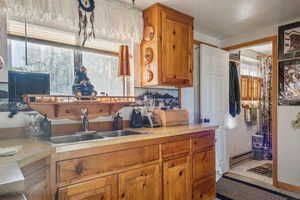 Kitchen with a baseboard heating unit, light countertops, and a healthy amount of sunlight