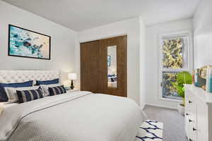 Bedroom featuring light colored carpet, baseboards, and a textured ceiling