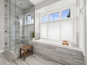 Full bath featuring a garden tub and a stall shower