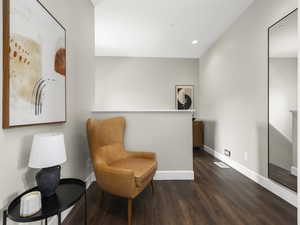 Sitting room featuring recessed lighting, baseboards, and dark wood-style flooring