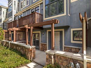 Entrance to property with stucco siding