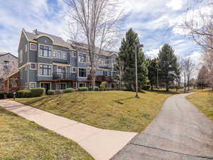 Exterior space with stucco siding and a front lawn