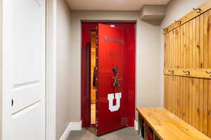 Mudroom featuring carpet and baseboards