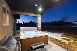 View of patio featuring a hot tub