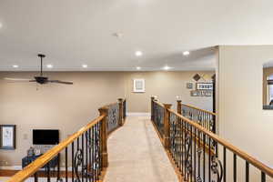 Corridor featuring recessed lighting, baseboards, an upstairs landing, and carpet