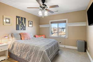 Bedroom with visible vents, baseboards, a ceiling fan, and carpet flooring