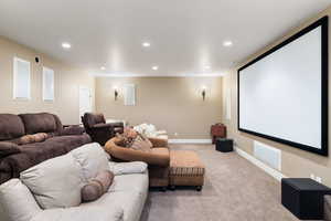 Cinema with recessed lighting, light colored carpet, and baseboards