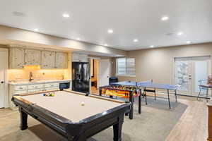 Playroom with billiards, recessed lighting, a sink, light wood-style floors, and french doors