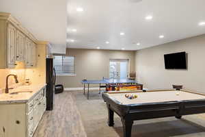 Rec room featuring a sink, recessed lighting, light wood-style floors, pool table, and baseboards