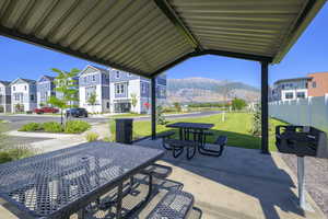 View of patio with a mountain view, a residential view, and outdoor dining space