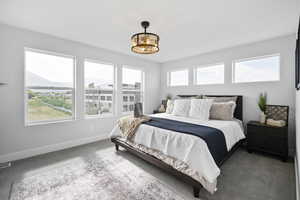 Carpeted bedroom with visible vents and baseboards