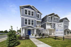 View of front of property with a front yard and board and batten siding