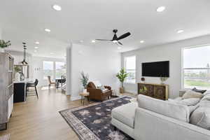 Living room with recessed lighting, baseboards, light wood-style flooring, and a ceiling fan