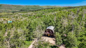 View of subject property featuring a forest and a mountainous background