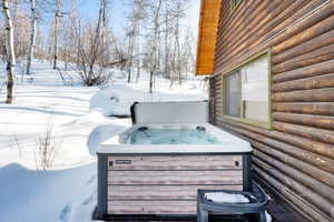 Snow covered deck with a hot tub