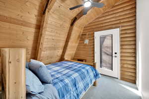 Bedroom with wooden ceiling, lofted ceiling with beams, a ceiling fan, and carpet floors