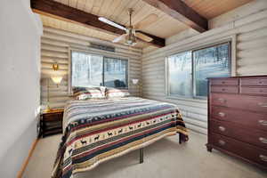 Carpeted bedroom featuring a ceiling fan, beam ceiling, wood ceiling, and baseboards