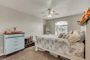 Bedroom with carpet flooring and a ceiling fan