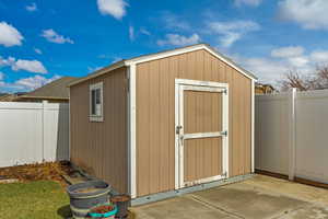 View of shed featuring a fenced backyard