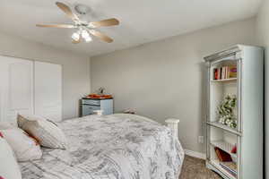 Bedroom with carpet flooring, a ceiling fan, a closet, and baseboards