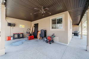 View of patio featuring area for grilling and a ceiling fan