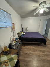 Bedroom with a ceiling fan and wood finished floors