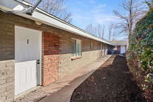 View of property exterior featuring brick siding