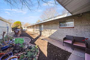 View of yard with fence and a patio