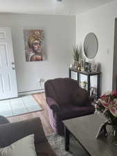 Living room featuring a baseboard radiator and wood finished floors