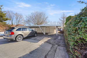 View of car parking featuring a carport