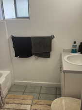 Full bathroom with tile patterned flooring, vanity, and baseboards