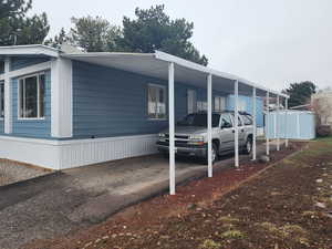 View of side of property with a storage unit and an outbuilding