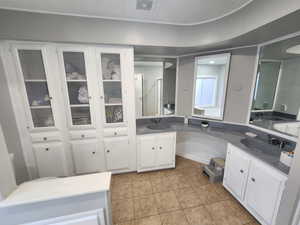 Full bath featuring double vanity, visible vents, and a sink