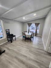 Dining area featuring beam ceiling, wood finished floors, and baseboards